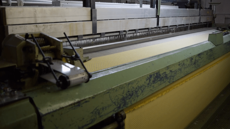 gif of a loom in operation weaving fabric for heritage blankets